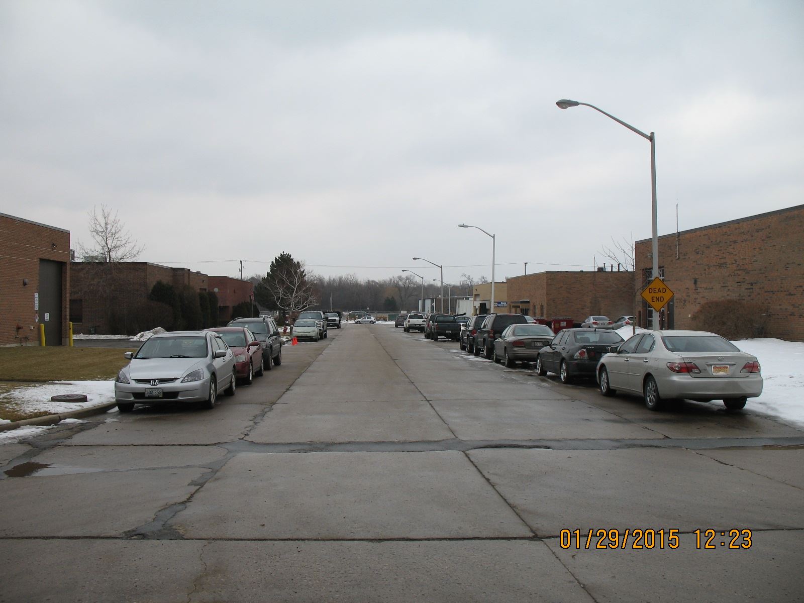 Cracked Street Lined with Cars