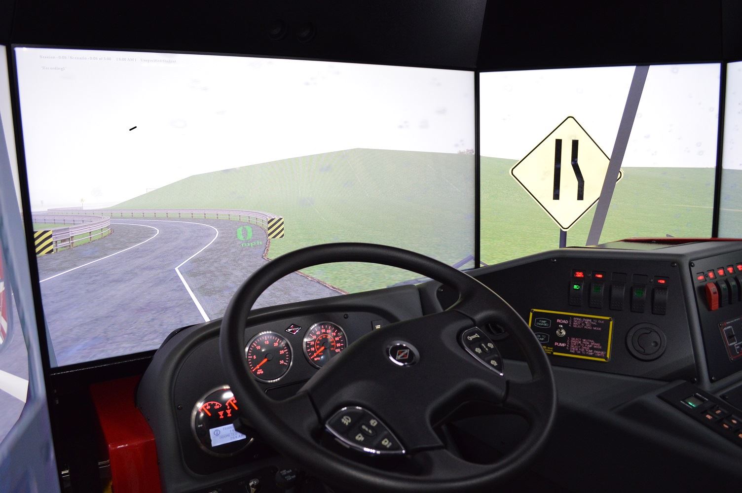 The driver's seat of the regional driving simulator is surrounded by screens used to project roadway scenarios.