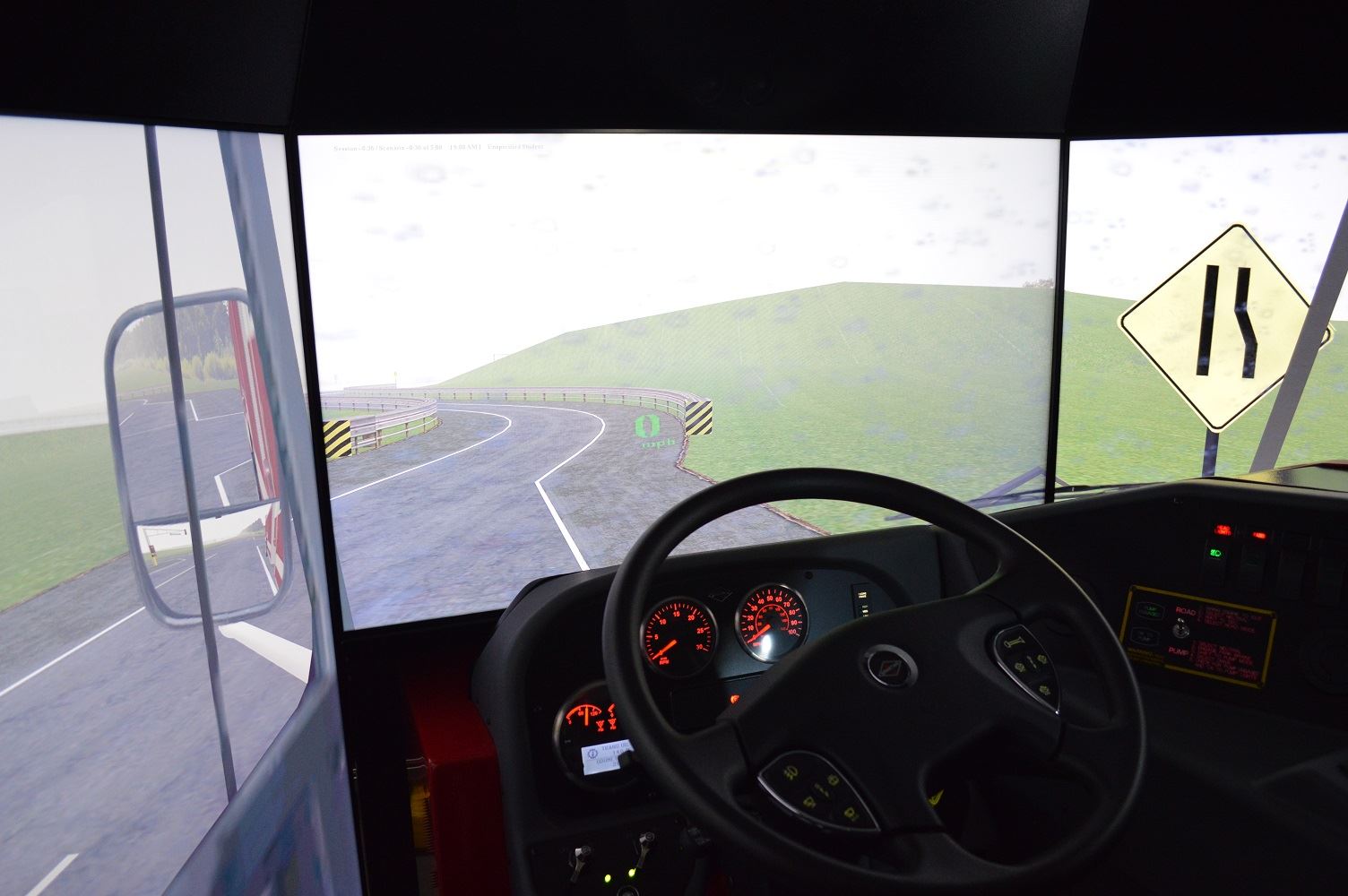 The driver's seat of the regional driving simulator is surrounded by screens used to project roadway scenarios.